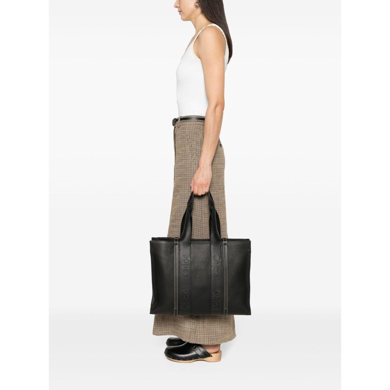 Front view with bag zipped and handles upright.